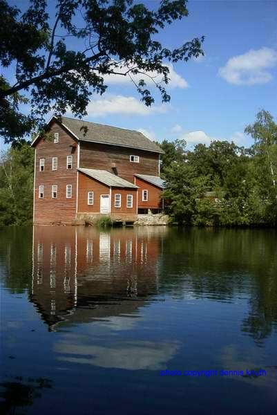 The Dells Mill reflects vertically on the Dells Pond