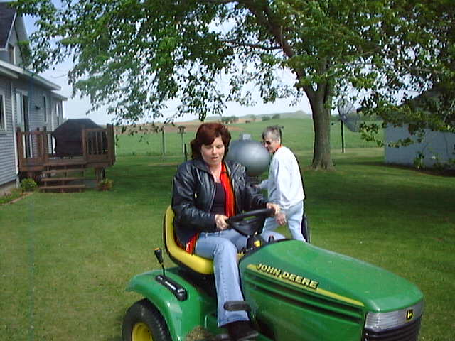 Rose Drives the John Deere lawn mower