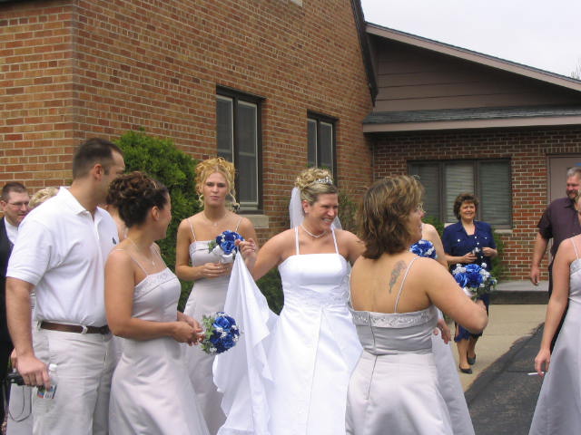 Brides maids gather round in the parking lot