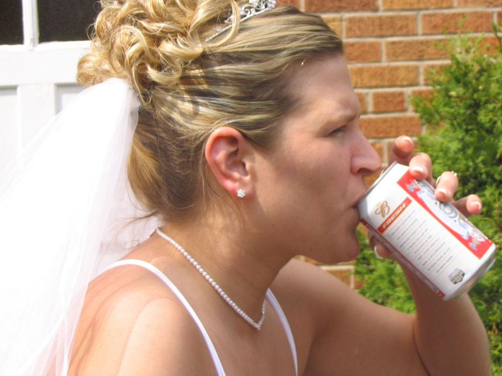 The bride drinking a beer