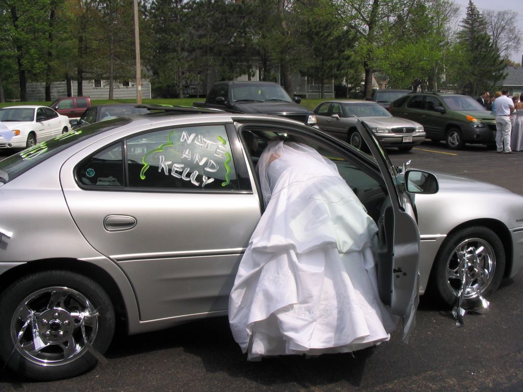 It's hard trying to get into a small car with a wedding dress