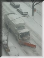 A garbage truck snow plow