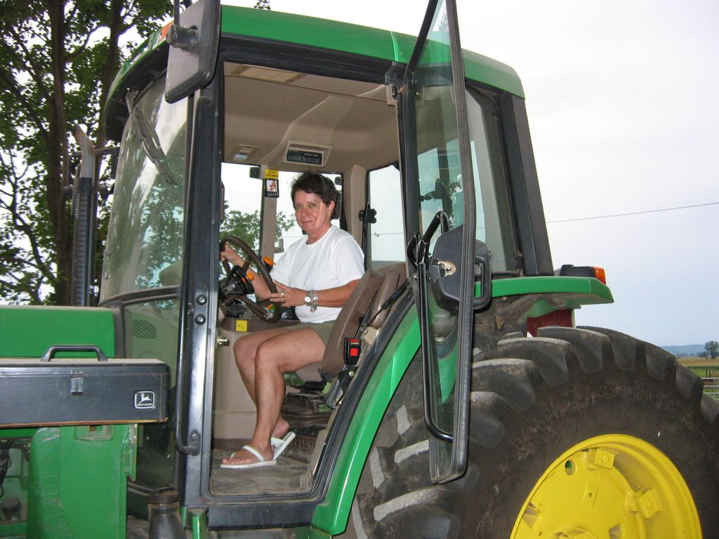 Norma drives Gary's John Deere tractor
