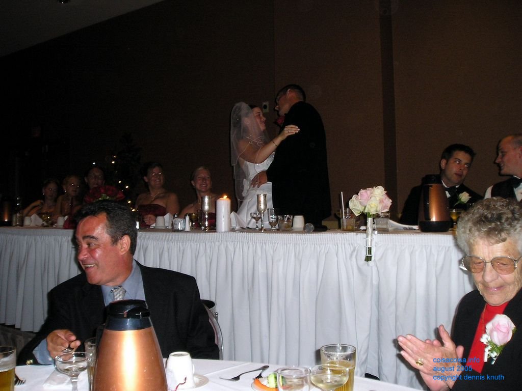 Helton smiles at the newly wed's kissing