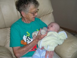 Great Grandma Emogene feeds baby Jared