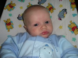 Jared under 3 months in a blue bassinette