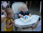 Cousin watches Jared with his cake