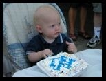 Jared approaches his first birthday cake