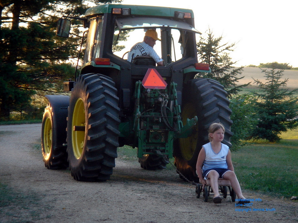 Gary pulls Kelsey by tractor