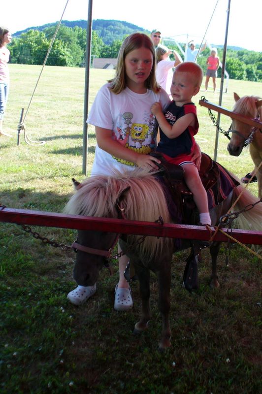 Jared Rides a pony and Kelsey helps