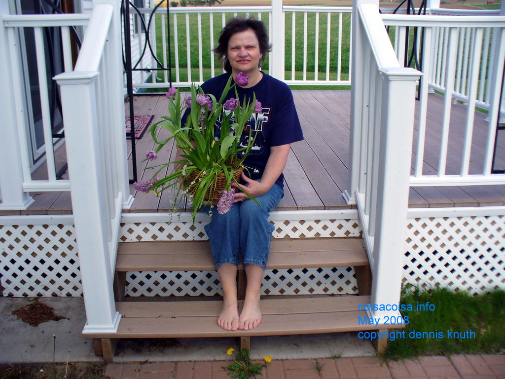 Sherri on the deck steps with flowers