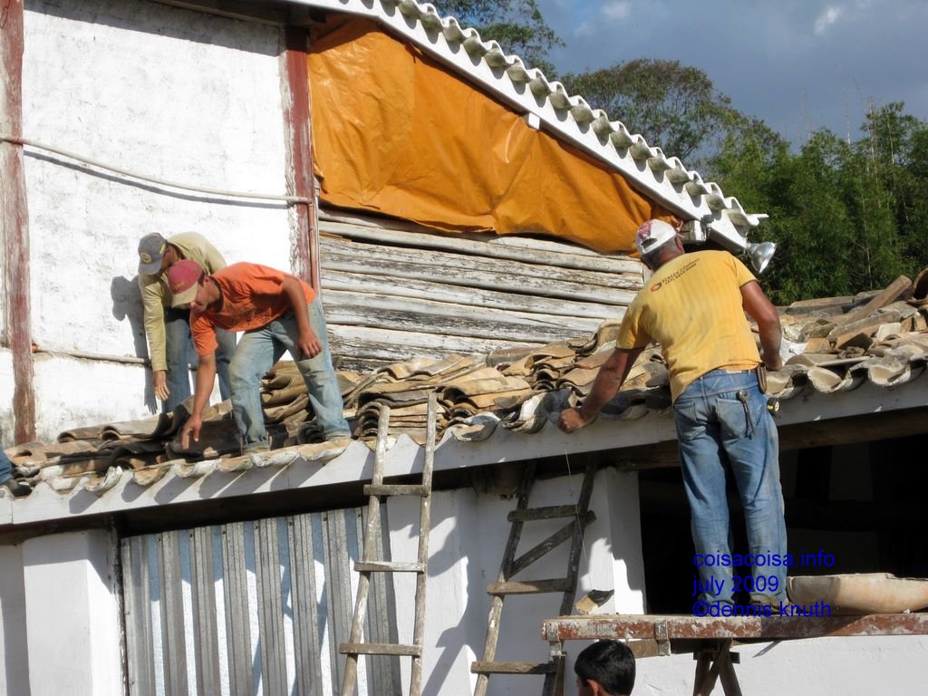 Fixing a roof on the coffee farm