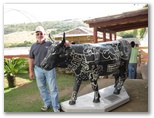 Gary shows off the statue of a cow on the plantation