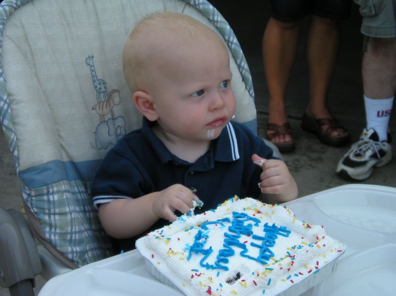 Jared approaches his first birthday cake