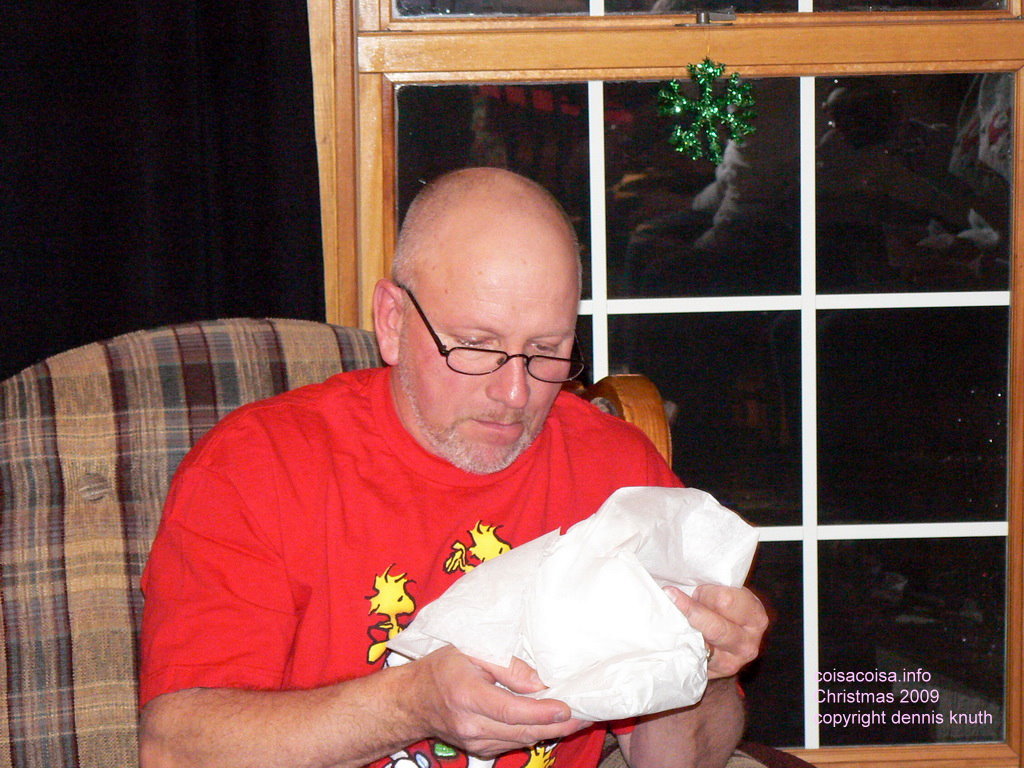 Gary sudiously opens a gift