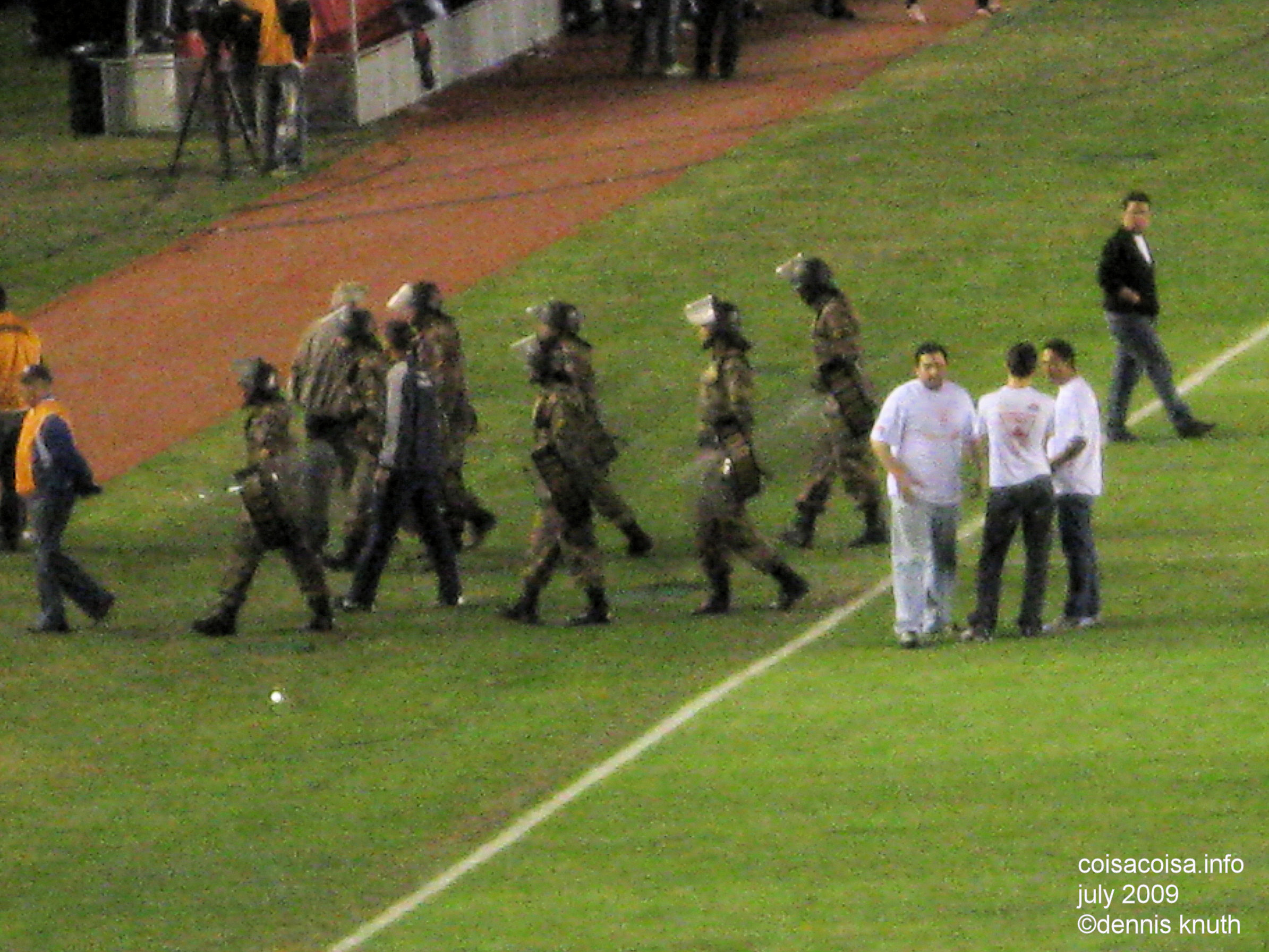 Armed guards escort players off the field