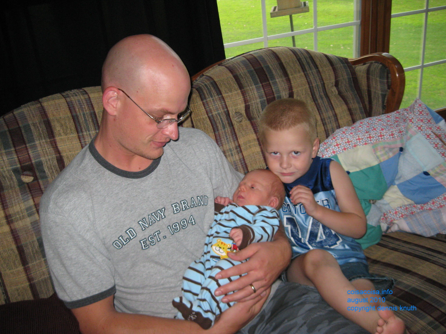 Jared looks suspicious with his dad holding new cousin Colin