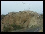 Boulder and desert rain