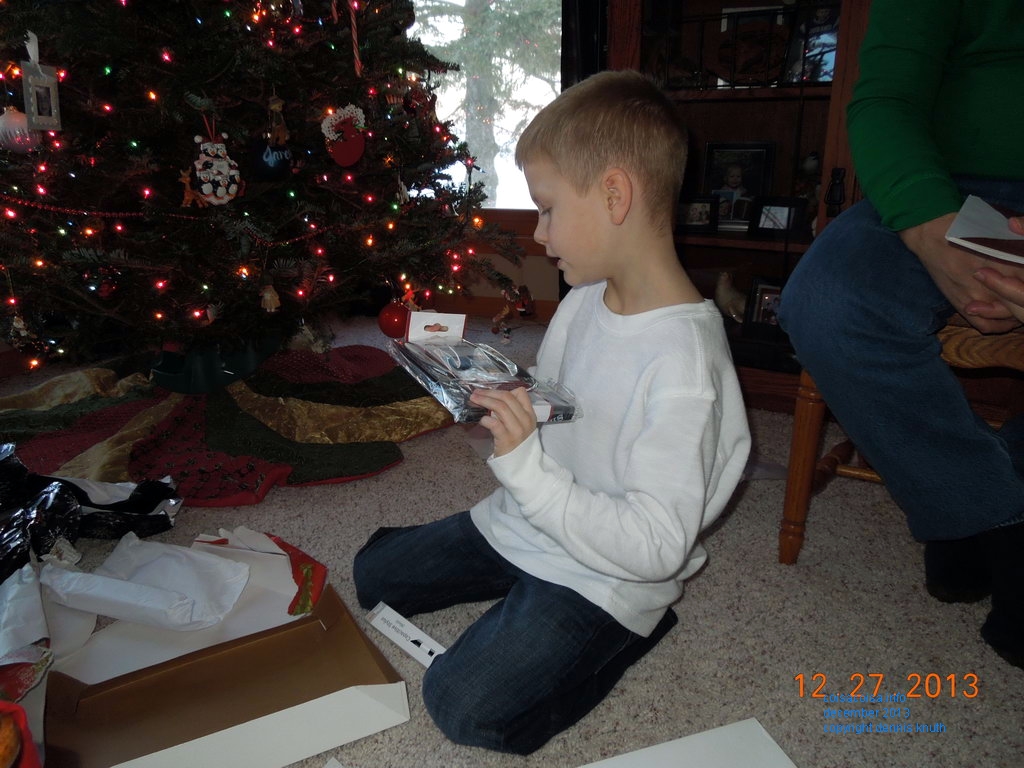 Jared opens a gift at Christmas 2013