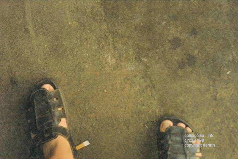 Man's feet in sandals on a a Garage Floor in Wisconsin