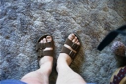 Sandaled feet on carpet